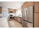 Beautiful kitchen featuring stainless steel appliances, wood cabinets and a view into other areas of the home at 9817 Kernville Dr, Las Vegas, NV 89134