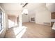An open concept living room with wood floors, neutral walls and seamless access to other areas of the home at 9817 Kernville Dr, Las Vegas, NV 89134