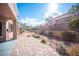 Private backyard patio area with brick pavers, lush landscaping, and a covered outdoor space at 9817 Kernville Dr, Las Vegas, NV 89134