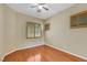 Bedroom with hardwood floors, neutral walls, and plantation shutters at 100 Woolman Rink Ave, Las Vegas, NV 89123
