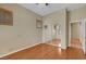 Bedroom with hardwood floors, a ceiling fan, plantation shutters, and a mirrored closet at 100 Woolman Rink Ave, Las Vegas, NV 89123