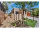 Neutral colored home with xeriscaped yard, small patch of grass, and well-maintained walkway at 100 Woolman Rink Ave, Las Vegas, NV 89123