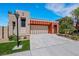 Charming single-Gathering home featuring a neutral palette and an attached two-car garage with an extra-long driveway at 100 Woolman Rink Ave, Las Vegas, NV 89123