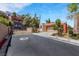 Exterior view of the home from street showing a gated entry and other homes at 100 Woolman Rink Ave, Las Vegas, NV 89123