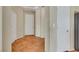 Hallway features tile floors and white doors with a tray ceiling and view to the living area at 100 Woolman Rink Ave, Las Vegas, NV 89123