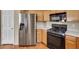 Kitchen featuring stainless steel appliances, gas range, maple cabinetry, and easy access to a utility closet at 100 Woolman Rink Ave, Las Vegas, NV 89123