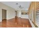 Open floor plan with wood floors, neutral walls, view of the kitchen, and two entryways with custom shutters at 100 Woolman Rink Ave, Las Vegas, NV 89123