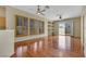 Spacious living room with wood floors, lots of windows, custom shutters, ceiling fans, and a back patio entrance at 100 Woolman Rink Ave, Las Vegas, NV 89123