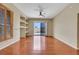 Spacious living room featuring hardwood floors, built-in shelving, and sliding glass doors to the outside patio at 100 Woolman Rink Ave, Las Vegas, NV 89123
