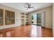 A spacious living room includes hardwood floors, built-in shelves and shuttered windows, and leads to an outdoor patio at 100 Woolman Rink Ave, Las Vegas, NV 89123
