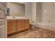 Well-lit bathroom features a vanity, toilet, and shower-tub combo with tiled walls at 1000 Duckhorn Ct # 102, Las Vegas, NV 89144
