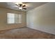Bedroom featuring neutral walls, carpet floors, ceiling fan, and two windows at 1000 Duckhorn Ct # 102, Las Vegas, NV 89144