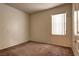Cozy bedroom with neutral walls, carpeted floor, and a window with blinds at 1000 Duckhorn Ct # 102, Las Vegas, NV 89144