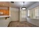 Dining room with beige walls, hanging light fixture, and view into kitchen at 1000 Duckhorn Ct # 102, Las Vegas, NV 89144