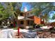 Exterior of apartment building with tan and orange paint and sidewalks surrounded by trees at 1000 Duckhorn Ct # 102, Las Vegas, NV 89144