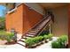 Condo exterior with tan paint, stairs to the front door, and green shrubbery at 1000 Duckhorn Ct # 102, Las Vegas, NV 89144