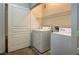 Efficient laundry room with washer, dryer, and shelving for storage at 1000 Duckhorn Ct # 102, Las Vegas, NV 89144