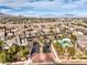 An aerial view of the community showing well-maintained homes and lush landscaping under a blue sky at 10205 Birch Bluff Ln, Las Vegas, NV 89145