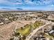 An aerial view featuring a community near a golf course, with distant city views and mountains at 10205 Birch Bluff Ln, Las Vegas, NV 89145