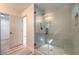 This bathroom features a tiled shower with a glass door and a built-in bench at 10205 Birch Bluff Ln, Las Vegas, NV 89145