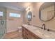 Elegant bathroom showcasing double sinks, modern lighting, and a glass-enclosed shower at 10205 Birch Bluff Ln, Las Vegas, NV 89145