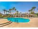 Community pool surrounded by mature landscaping and lounge chairs at 10205 Birch Bluff Ln, Las Vegas, NV 89145