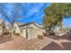 Charming home exterior featuring desert landscaping, including rocks and bushes, along with a secure gated entry at 10205 Birch Bluff Ln, Las Vegas, NV 89145