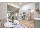 This kitchen has stainless steel appliances, quartz countertops, and access to the living room at 10205 Birch Bluff Ln, Las Vegas, NV 89145