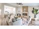 Open concept living area with modern fireplace, neutral decor, and ample seating at 10205 Birch Bluff Ln, Las Vegas, NV 89145