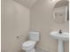 Powder bathroom with round mirror, pedestal sink, and a modern toilet at 10630 Lunar Crest Ave, Las Vegas, NV 89129