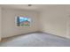 Primary bedroom with a window providing natural light and a carpeted floor at 10630 Lunar Crest Ave, Las Vegas, NV 89129