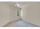 Carpeted bedroom with neutral colored walls, window, and ceiling fan at 10630 Lunar Crest Ave, Las Vegas, NV 89129
