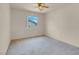 Bedroom showcasing a ceiling fan, a window view, and carpeted flooring at 10630 Lunar Crest Ave, Las Vegas, NV 89129