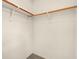 Bright closet showing neutral paint, wood shelving rods and tile floors at 10630 Lunar Crest Ave, Las Vegas, NV 89129
