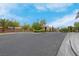 Gated community entrance with lush landscaping at 10630 Lunar Crest Ave, Las Vegas, NV 89129