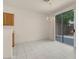 Dining room with tile flooring, chandelier and glass sliding doors leading to an outdoor area at 10630 Lunar Crest Ave, Las Vegas, NV 89129