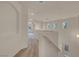 Bright hallway featuring natural light, white walls, and updated flooring at 10630 Lunar Crest Ave, Las Vegas, NV 89129