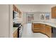 The kitchen has tile flooring, standard appliances, and wooden cabinets at 10630 Lunar Crest Ave, Las Vegas, NV 89129