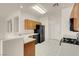 Well-lit kitchen featuring black appliances and ample wooden cabinets for storage at 10630 Lunar Crest Ave, Las Vegas, NV 89129