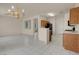 Bright open kitchen with tile floors, view into living room and standard appliances at 10630 Lunar Crest Ave, Las Vegas, NV 89129