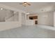 Expansive living room featuring tile flooring, staircase, and open layout to kitchen at 10630 Lunar Crest Ave, Las Vegas, NV 89129