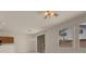Spacious living room with ceiling fan, sliding glass door, and light-colored walls at 10630 Lunar Crest Ave, Las Vegas, NV 89129