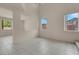 Bright, open-concept living room featuring tile flooring and multiple windows at 10630 Lunar Crest Ave, Las Vegas, NV 89129