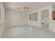 Bright living room features tile flooring, a ceiling fan, and large windows at 10630 Lunar Crest Ave, Las Vegas, NV 89129