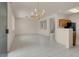 Open living room with tile flooring, chandelier and view of other areas in the house through openings in the wall at 10630 Lunar Crest Ave, Las Vegas, NV 89129