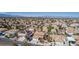 Expansive aerial view of the residential neighborhood, capturing houses, palm trees and city skyline at 1066 Aspen Valley Ave, Las Vegas, NV 89123