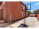 Backyard view of the home shows a basketball hoop and detached garage at 1066 Aspen Valley Ave, Las Vegas, NV 89123