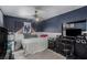 Cozy bedroom with dark blue walls, fan, and decorated with sports memorabilia at 1066 Aspen Valley Ave, Las Vegas, NV 89123