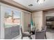 Cozy breakfast nook adjacent to the pool featuring a glass table and slider with backyard view at 1066 Aspen Valley Ave, Las Vegas, NV 89123