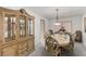 Elegant dining room featuring a wooden table, decorative china cabinet, and soft lighting at 1066 Aspen Valley Ave, Las Vegas, NV 89123
